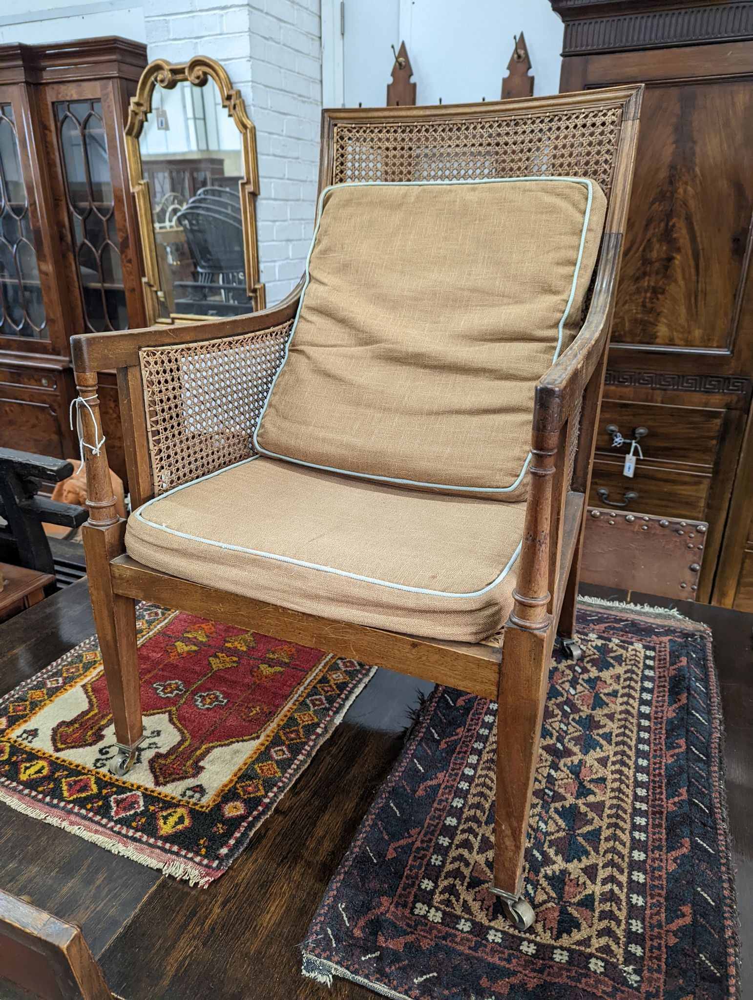 A Regency style mahogany bergere armchair, width 59cm, depth 56cm, height 97cm